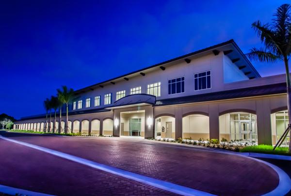 Exterior photo of LeeSar Regional Service Center at dusk. Red brick entry drive.